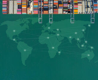A cargo ship in the ocean. A world map is transposed in the water.
